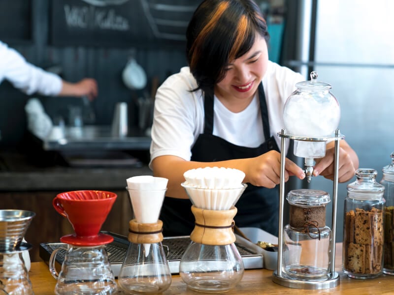 woman smiling at pourover coffee course